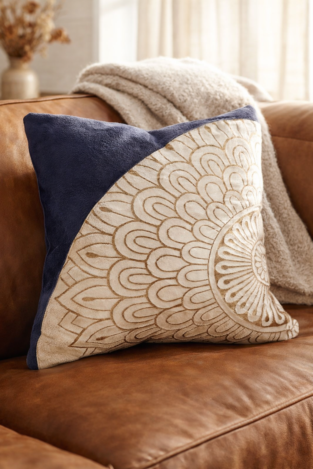 Decorative pillow with geometric pattern on a brown leather couch