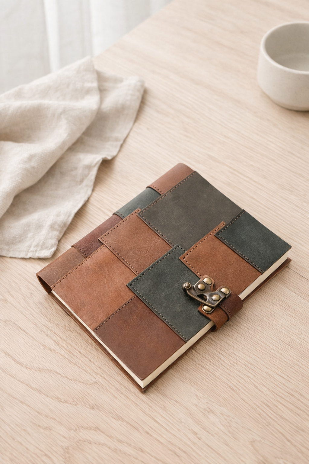 Leather patchwork travel journal styled with gift box and ribbon for gifting.