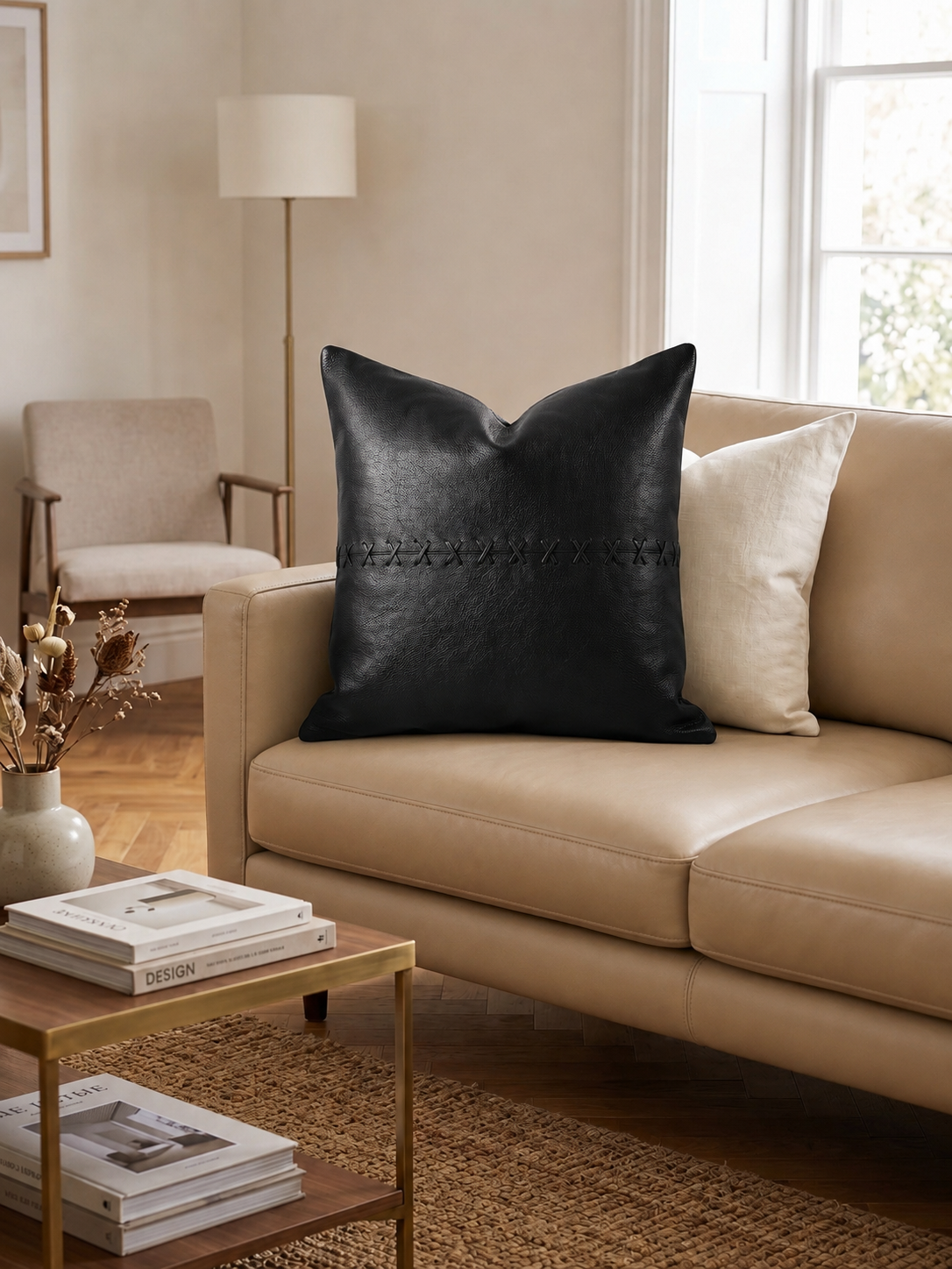 Handcrafted leather cushion cover in tan with black cross detailing