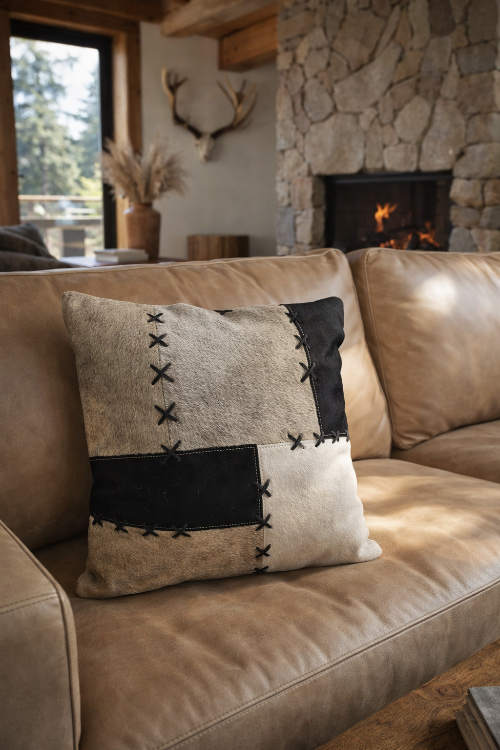 Square cowhide cushion cover 45x45 black grey cream patchwork close-up with laced stitching